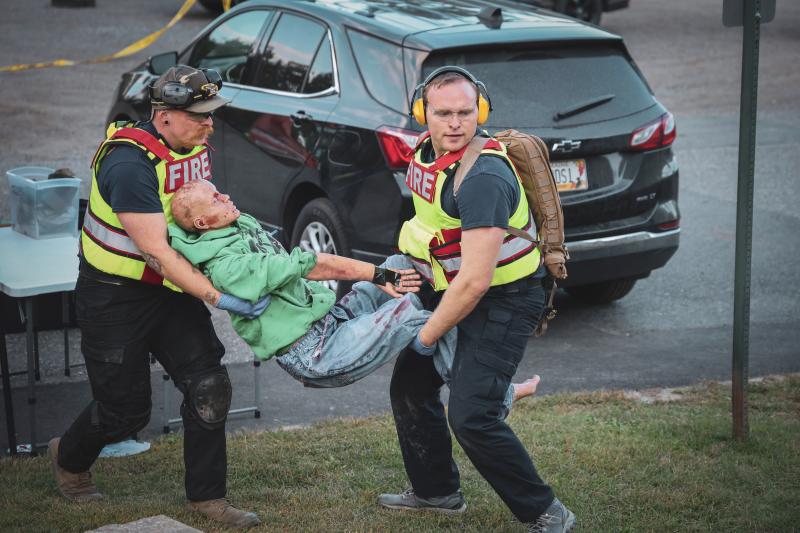 Carrying patients from the hot zone to the warm zone. (Photo courtesy Connor Howland/Camden Fire Dept.) Carrying patients from the hot zone to the warm zone. (Photo courtesy Connor Howland/Camden Fire Dept.)